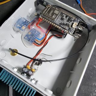 An ESP32-C5 sensor node with its sensor boards inside a junction box